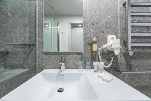 a bathroom with a white sink and a mirror at SPA Nida in Nida