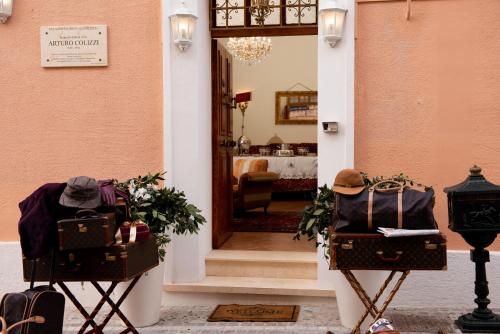 a hallway with two luggage stands in front of a door at Casa Isabella B&B in Rocca San Giovanni