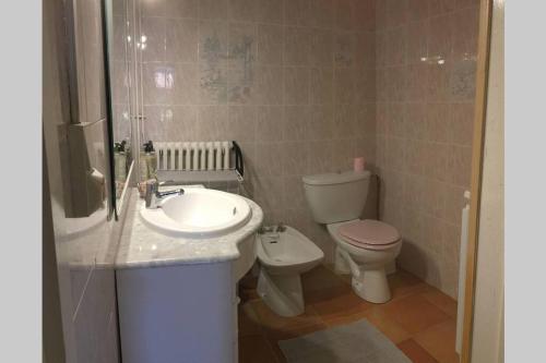 a bathroom with a toilet and a sink at Maison de charme confortable au cœur de la nature in Saint-André-de-Double