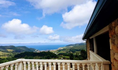 a balcony with a view of the ocean at AGROTURISMO ZUMINTXAZ in Mungia