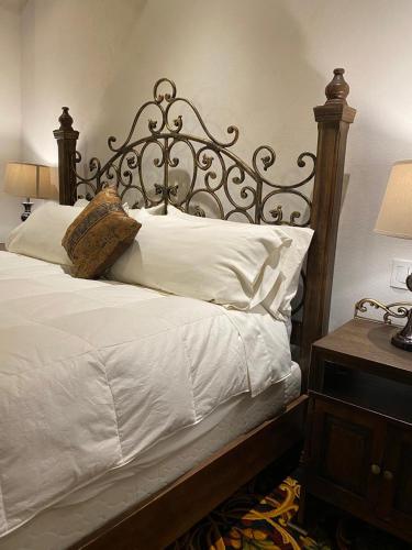 a bedroom with a large bed with white pillows at Hotel Quinta Mision in Creel