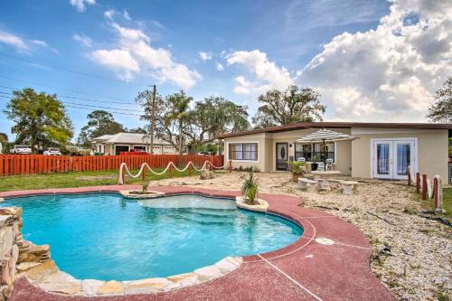 a house with a swimming pool in a yard at Cozy Melbourne Home with Deck and Pool 5 Mi to Beach! in Melbourne