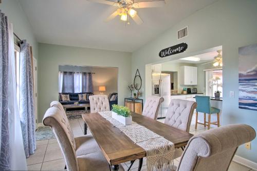 a dining room and living room with a table and chairs at Cozy Melbourne Home with Deck and Pool 5 Mi to Beach! in Melbourne