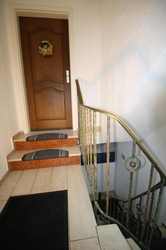 a stairway with a wooden door and a stair case at Komfort Ferienwohnung FEWO74-2 in Bremm