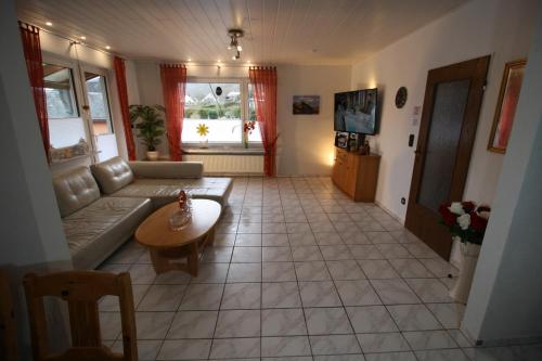 a living room with a couch and a table at Komfort Ferienwohnung FEWO74-2 in Bremm