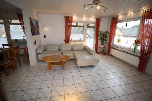 a living room with a couch and a table at Komfort Ferienwohnung FEWO74-2 in Bremm