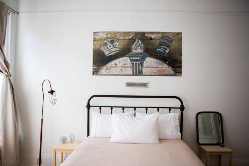 a bedroom with a bed and a painting on the wall at Object Hotel 1BR Shared Bath Room 2C in Bisbee