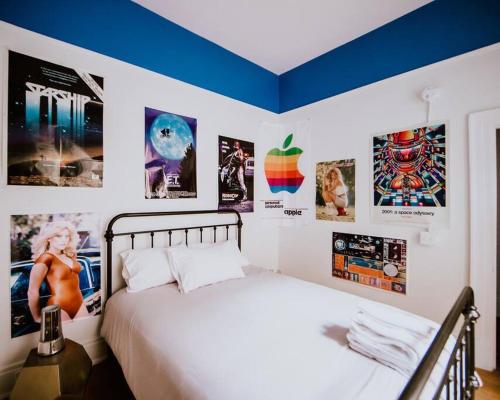 a bedroom with a bed and posters on the wall at Object Hotel 1BR Room 3E in Bisbee