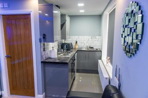 a kitchen with a sink and a counter top at Sawrey Serviced Apartments in Bradford