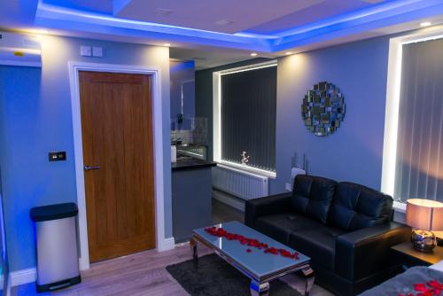 a living room with a couch and a table at Sawrey Serviced Apartments in Bradford