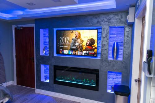 a wall with a flat screen tv on a wall at Sawrey Serviced Apartments in Bradford