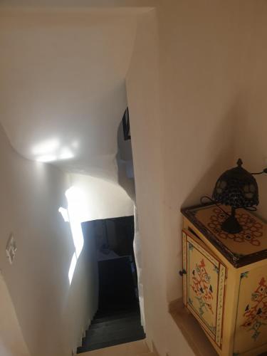 a stairway with a shadow of a light on the wall at Luxury studio at the heart of old Jaffa in Tel Aviv