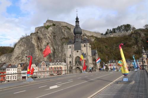 a street in front of a building with a mountain at Gîtes Sax 1 in Dinant