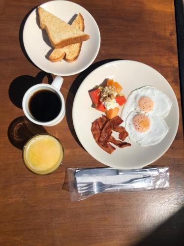 two plates of breakfast food and a cup of coffee at La Villa de Adelina in Ensenada