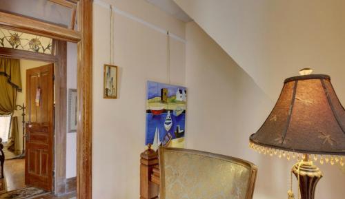a lamp and a chair in a living room at Garden House Bed and Breakfast in Hannibal