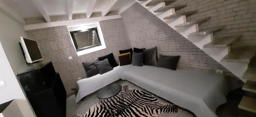 a room with a bed with pillows and a staircase at 5***** LOFT Loulé Historical Center in Loulé