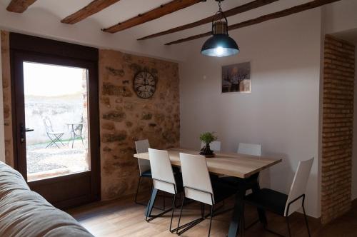 a dining room with a table and chairs and a window at La Casa El Cura in Campillo de Dueñas