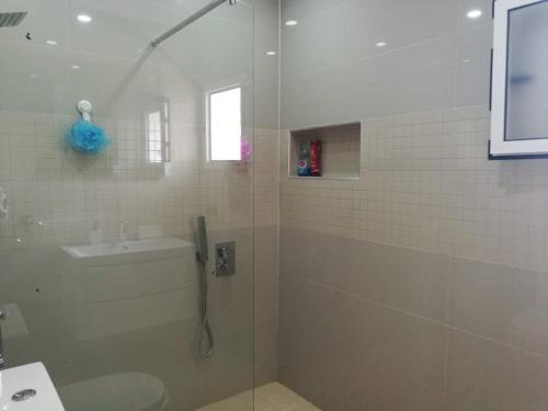 a bathroom with a shower and a toilet and a sink at 5 Guests - 10min Beach - Free Parking - PetsOK in Saidia 