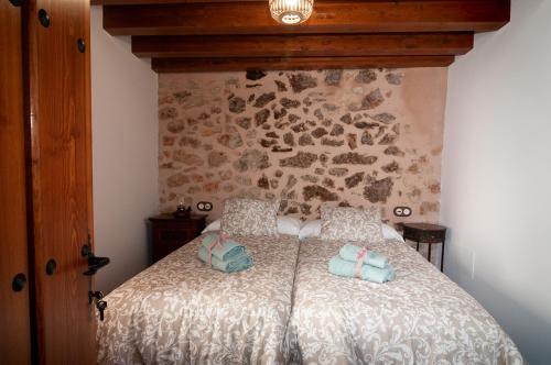 a bedroom with a bed with two pillows on it at La Casa El Cura in Campillo de Dueñas