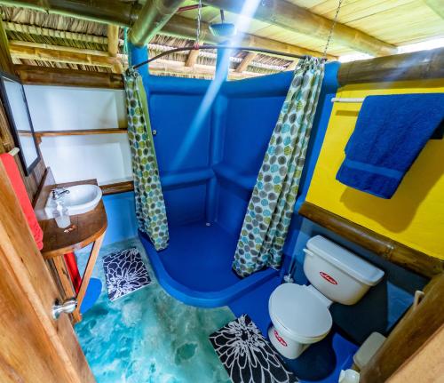 a bathroom in a bus with a toilet and a sink at Maracumbo Lodge in Mompiche
