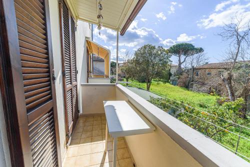 a white bench on a balcony with a view at Donoratico Comfort and Relax on the Etruscan Coast in Donoratico