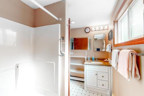 a bathroom with a shower and a sink at The Hideout in Rockaway Beach