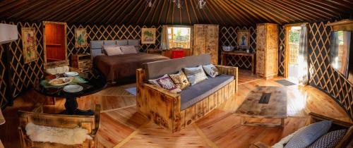 a living room with a couch and a bed at Glamping montain experience in São Joaquim