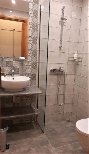 a bathroom with a sink and a shower at Castello Verde Plakias in Plakias