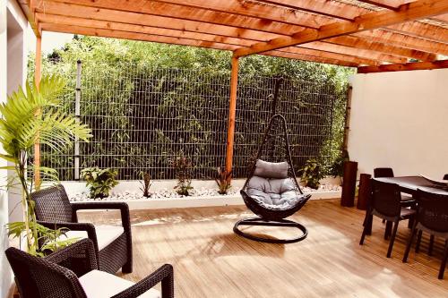 a patio with a chair and a table and a fence at InSide Furnas in Furnas