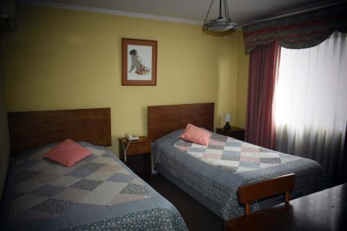 Ліжко або ліжка в номері Hotel Doria