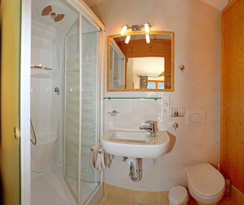 a bathroom with a sink and a shower at Lindenhof in Kitzbühel