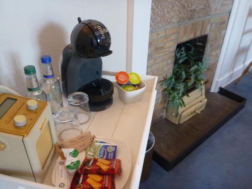 a kitchen with a table with food and a fireplace at Craigellachie Lodge in Craigellachie