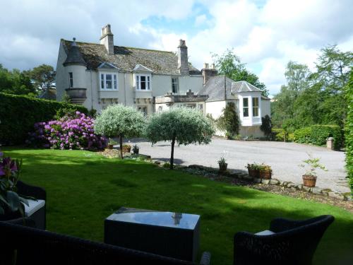 a house with a lawn in front of it at Craigellachie Lodge in Craigellachie