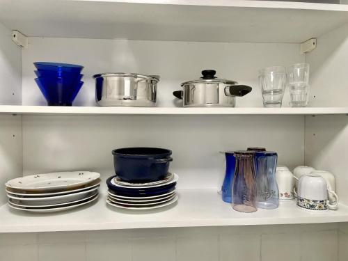 a shelf filled with plates and pots and pans at Apartment für Monteure Nr 4 in Kassel