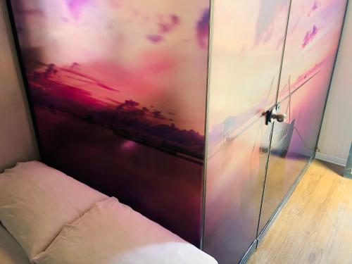 a glass door with a pillow next to a bed at Surfari Punta Rocas in Punta Negra