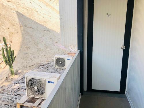 two speakers sitting on a counter next to a door at Surfari Punta Rocas in Punta Negra