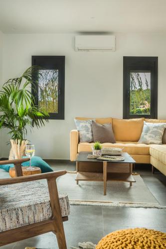 a living room with a couch and a table at Ionian Village in Lixouri