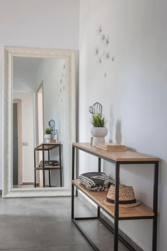 a room with a mirror and a shelf with hats at Ionian Village in Lixouri