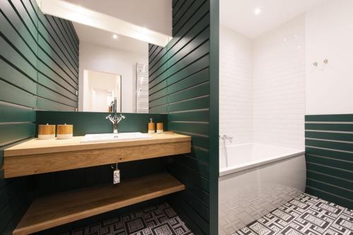 a bathroom with a sink and a tub at Out of Africa in Paris