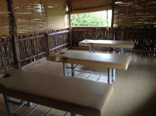 a room with two tables and a bench in it at AA Lodge Amboseli in Amboseli