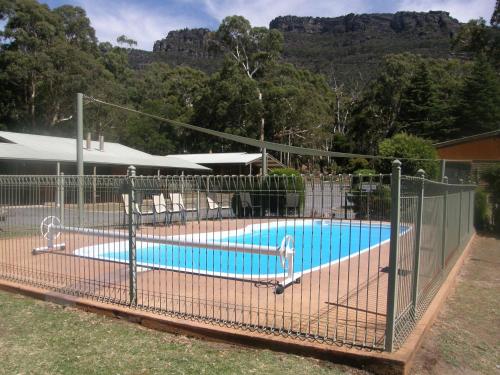 a swimming pool with a fence around it at Halls Gap Log Cabins in Halls Gap