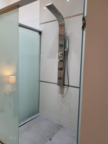 a shower with a glass door in a bathroom at GOLDEN SKY in Talara