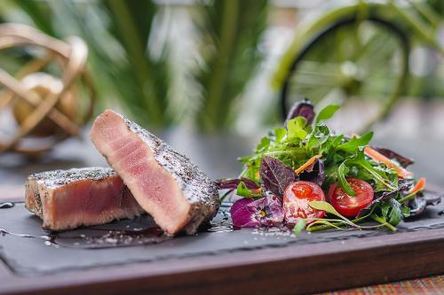 a plate of food with meat and a salad at Hotel Marquis Reforma in Mexico City