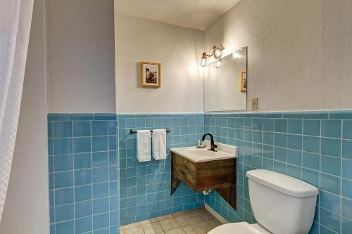 a blue tiled bathroom with a toilet and a sink at Loyal Duke Lodge in Salida