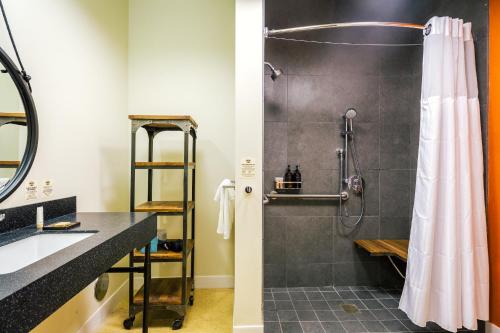 a bathroom with a shower and a sink at Rush Creek Lodge at Yosemite in Groveland