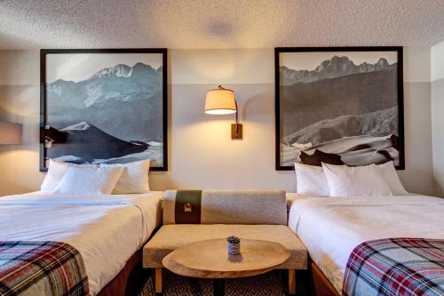 a hotel room with two beds and a table at Loyal Duke Lodge in Salida