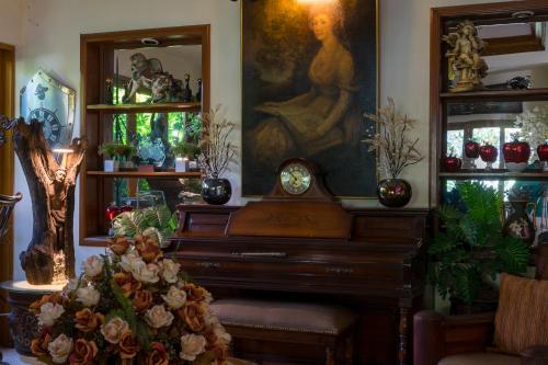 a room with a piano and a painting on the wall at El Jardín del Edén B&B Boutique in Cuernavaca