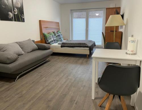 a living room with a couch and a table at Stilvoll Wohnen in Oldenburg Kreyenbrück Apartments in Oldenburg