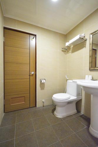 a bathroom with a toilet and a sink at Ji Li Ya Lan Homestay in Chenggong