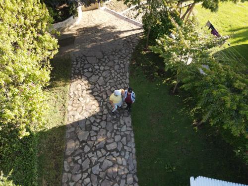 two people standing on a stone walkway at Hostal Mamá Hilda in Chugchilán